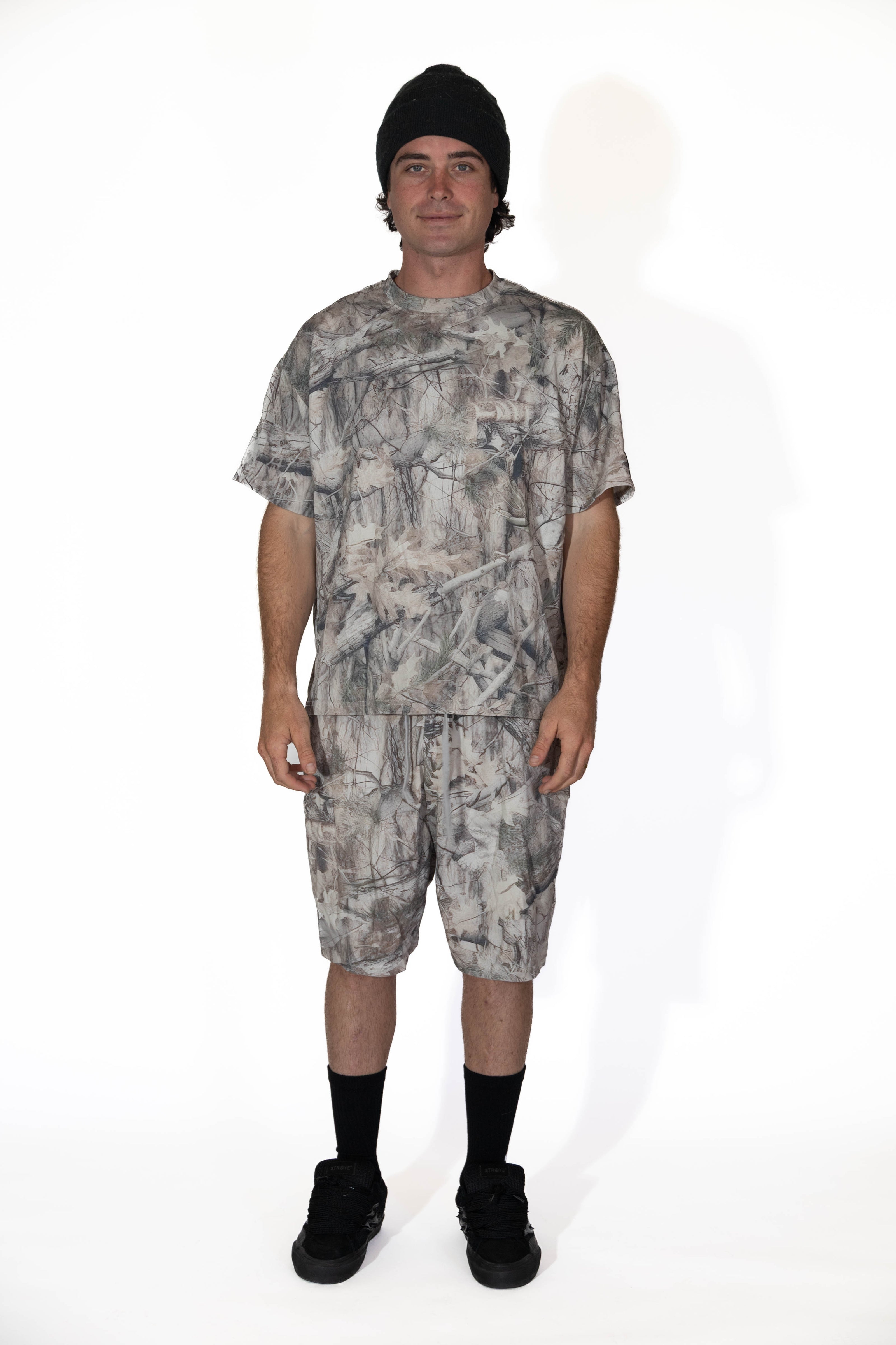 Person wearing a camouflage outfit on a white background