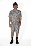 Person wearing a camouflage outfit on a white background