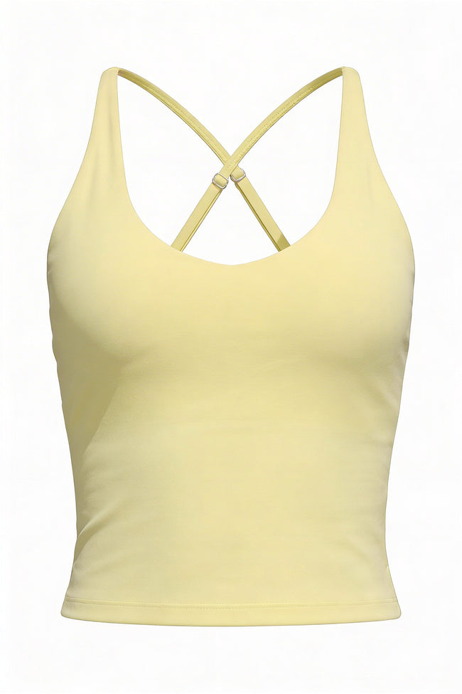 Yellow tank top with criss-cross straps on a white background