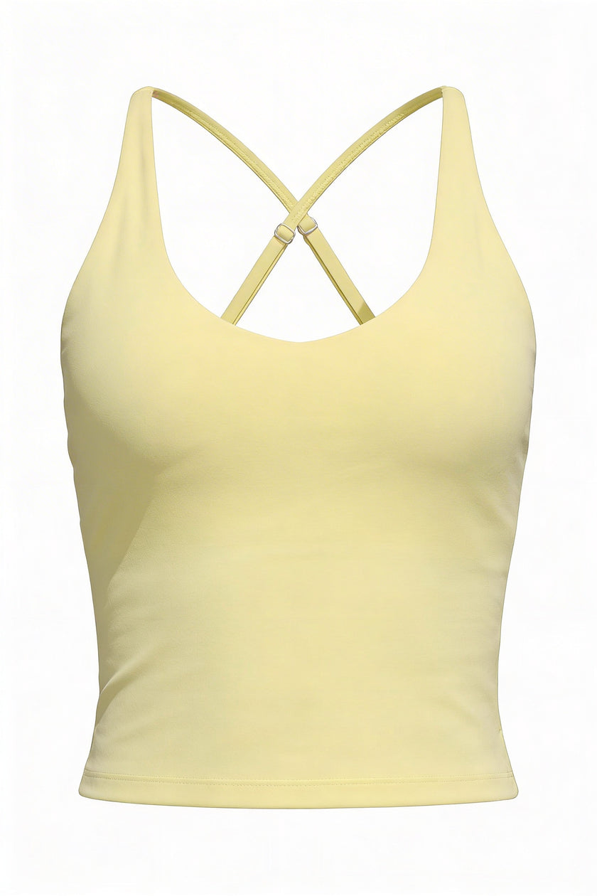 Yellow tank top with criss-cross straps on a white background